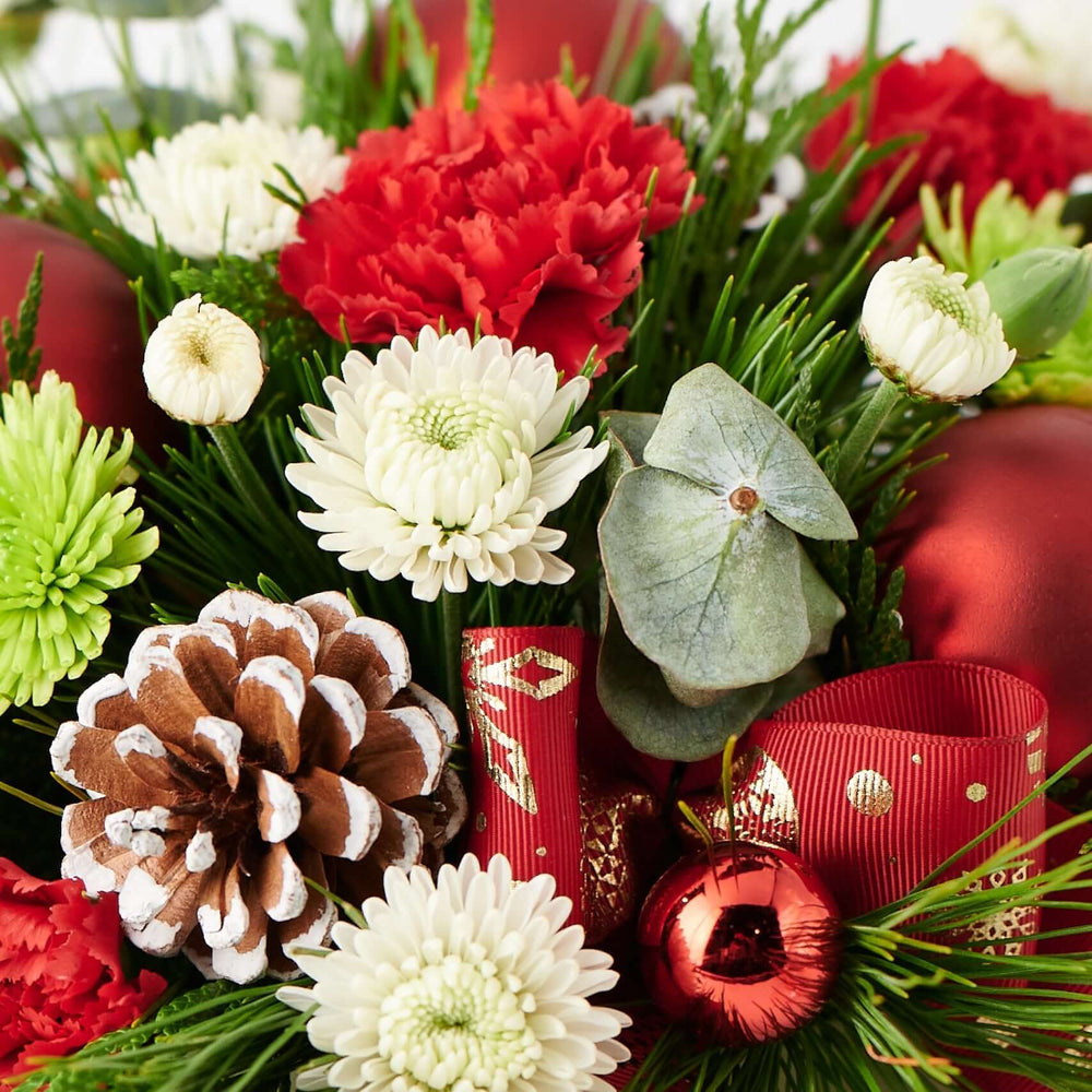 Holiday Season Floral Arrangement with Red Carnations and Daisies – how the gift is presented