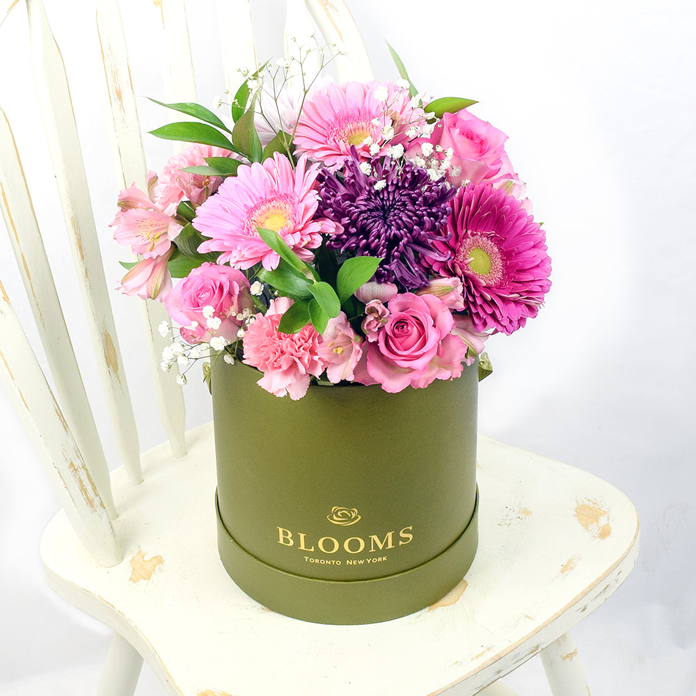 Pink and Purple Mixed Flower Arrangement with Chocolates in Tall Green Hat Box – how the gift is presented