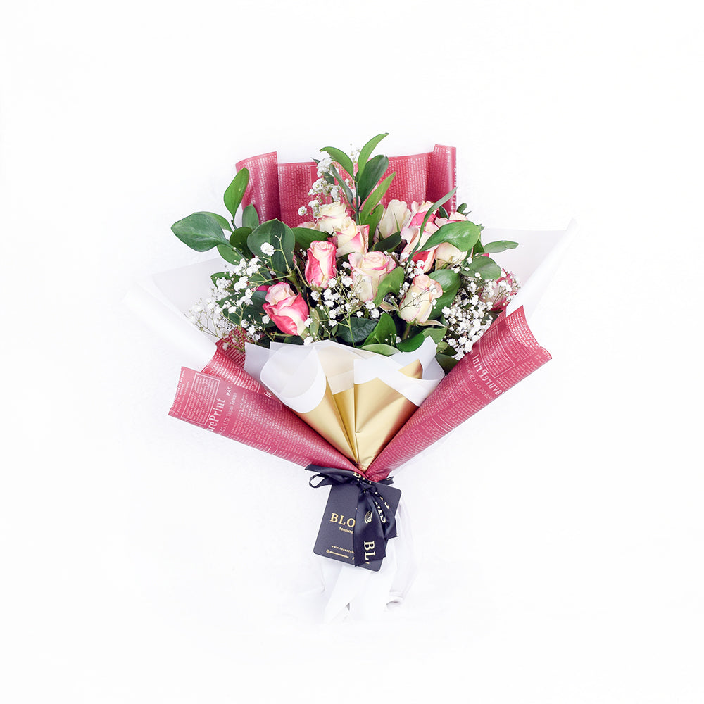 Deluxe Rose Bouquet Wrapped in Floral Paper with Salal – how the gift is presented