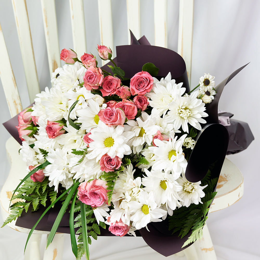 Medium Floral Wrap Bouquet with Pink Spray Roses and White Daisies – how the gift is presented